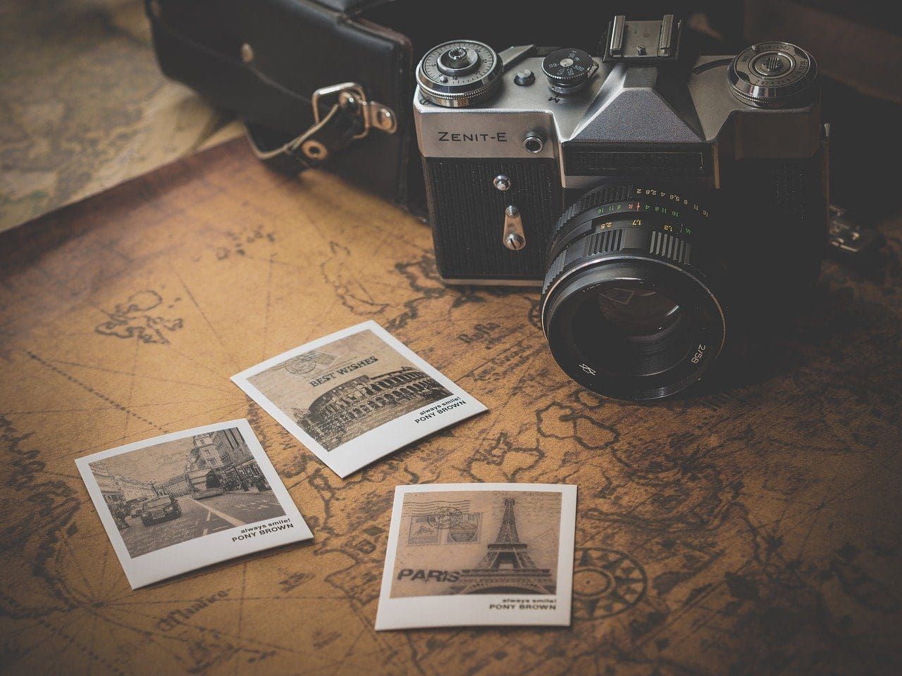 camera and travel photos on table