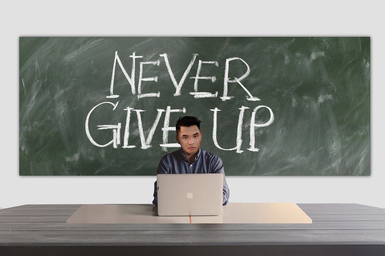 man sitting at his laptop contemplating entrepreneurship