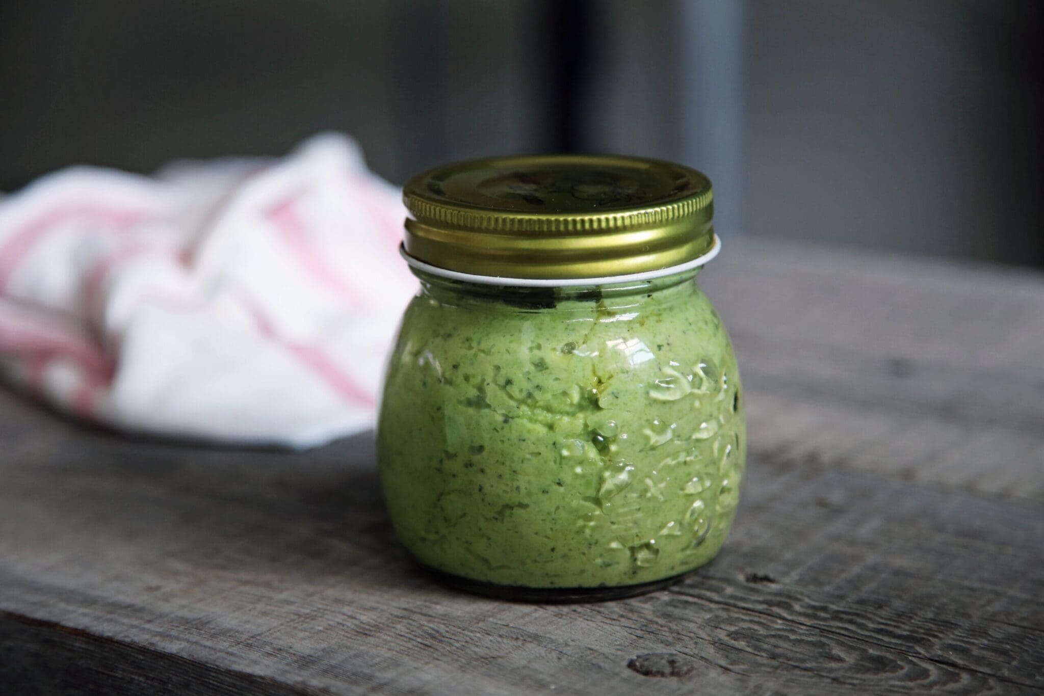 mason jar of mushy peas on a table